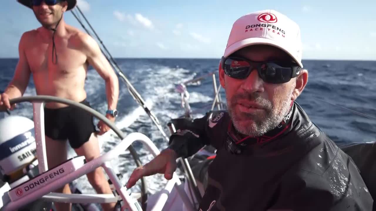 Closeup of chart plotter: We see the equator crossing. We see Jack on the aft pedestal and Carolijn in the hatchway prepping King Neptune's trident.