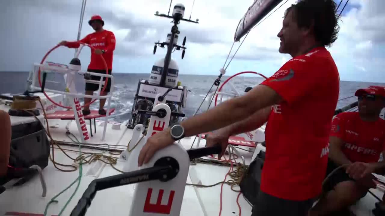 The crew sings Happy Birthday to Tamara in the cockpit. They have a present for her: Some food treat ("to share, to share" says Blair), a fish swim cap, and a card they all signed. She talks about it in Spanish.